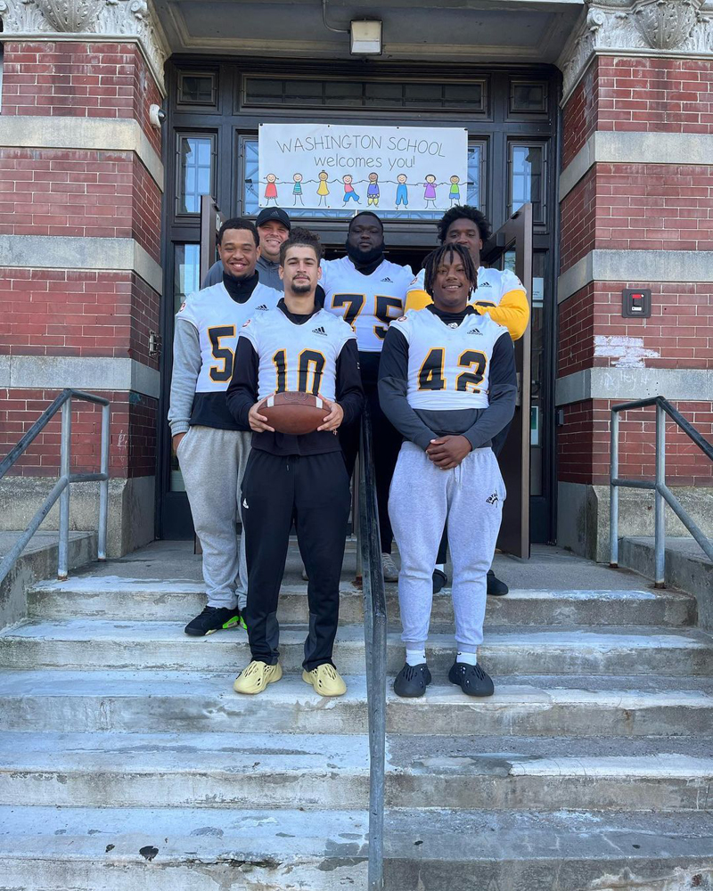 AIC football players preparing to spend time at a local elementary school reading to kids.